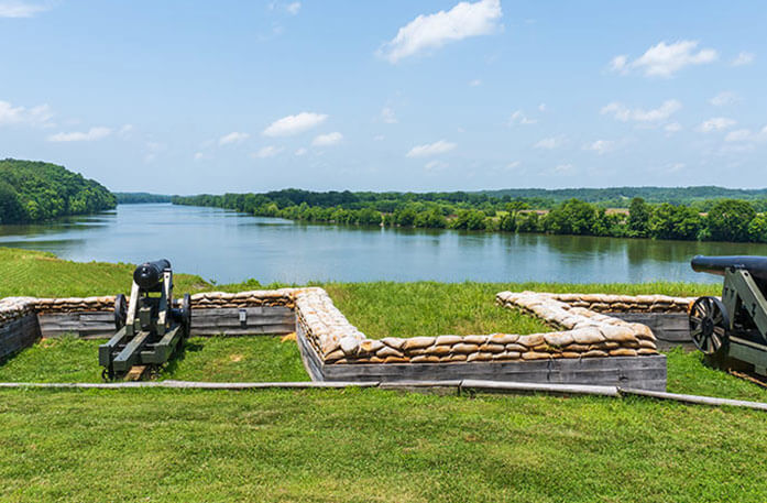 A pair pf cannons pointed towards a river