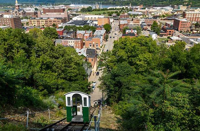 An aerial view of buildings from the top of Fenelon Place Elevator, where green and white cars travel the historic cable railway.