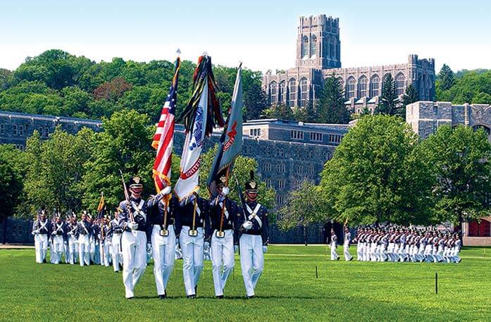 Military officers marching on a lawn at West Point