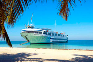 Grand Caribe anchored on a Caribbean beach