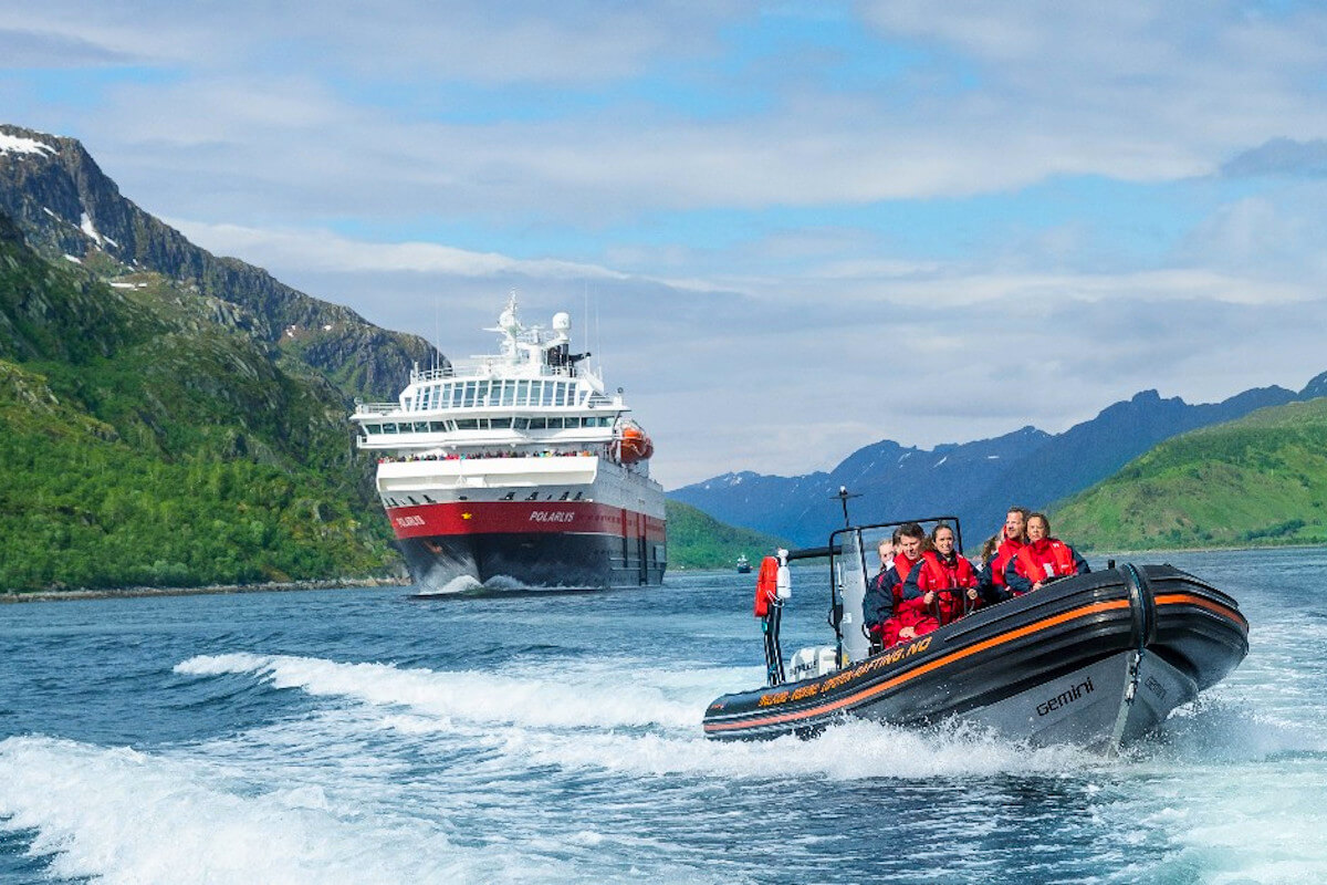 Hurtigruten Expeditions ship with zodiac filled with guests