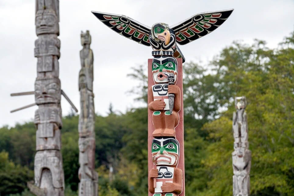 Totem poles line the landscape in the cemetery of Alert Bay.