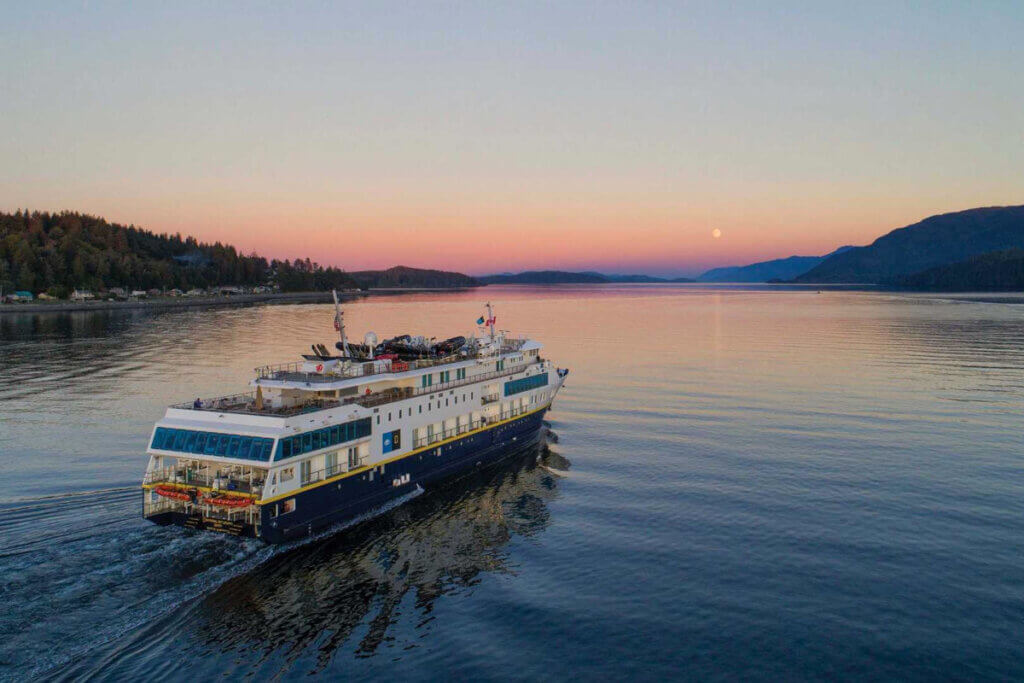 National Geographic ship sailing at sunset