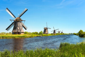 A series of Windmills lining a river