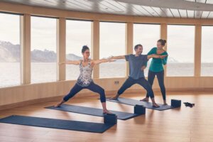 Cruise passengers partaking in a yoga class