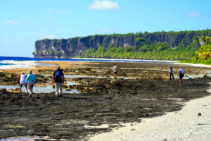 Cruise guests walking the coastline of Makatea Island