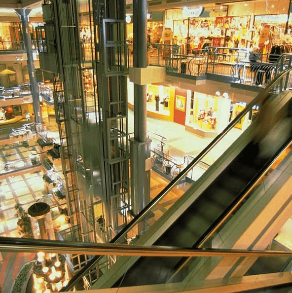 Interior of multi-level mall with elevators and escalators