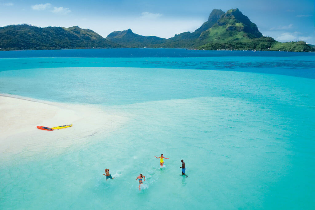 A group playing in the water in Bora Bora