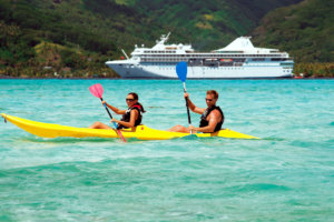 Kayakers exploring the South Pacific waters near Motu Mahana