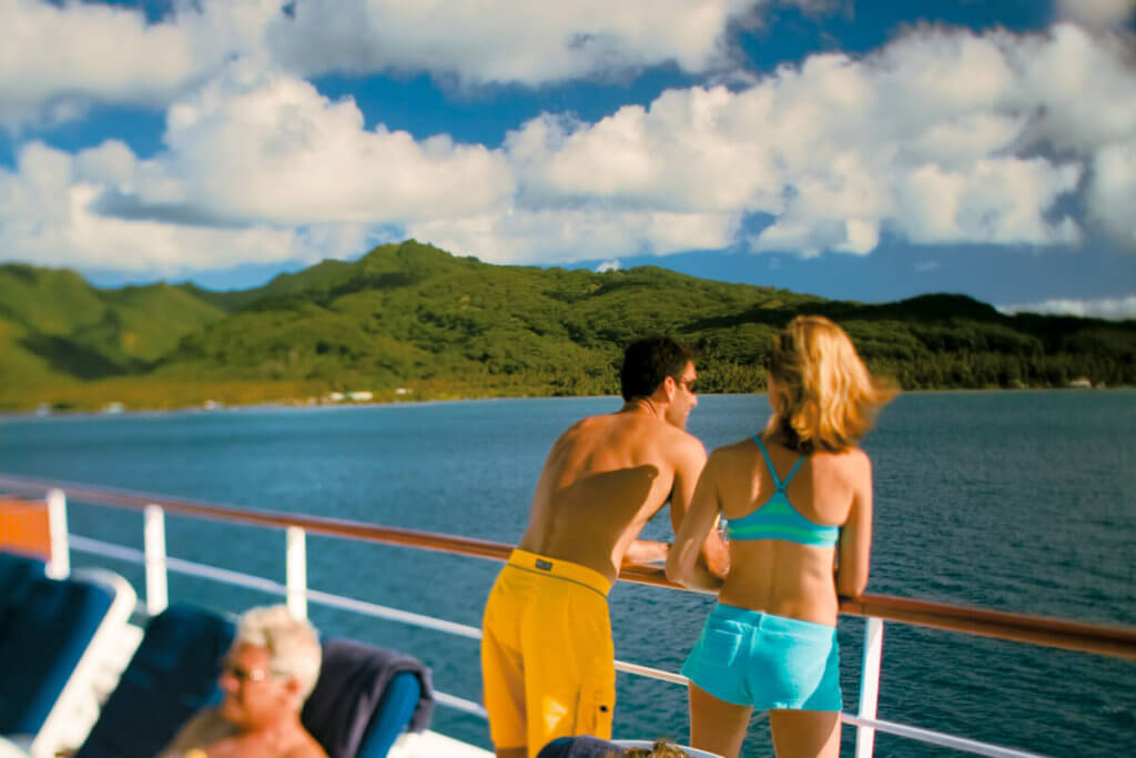A couple sunning on deck aboard the Paul Gauguin