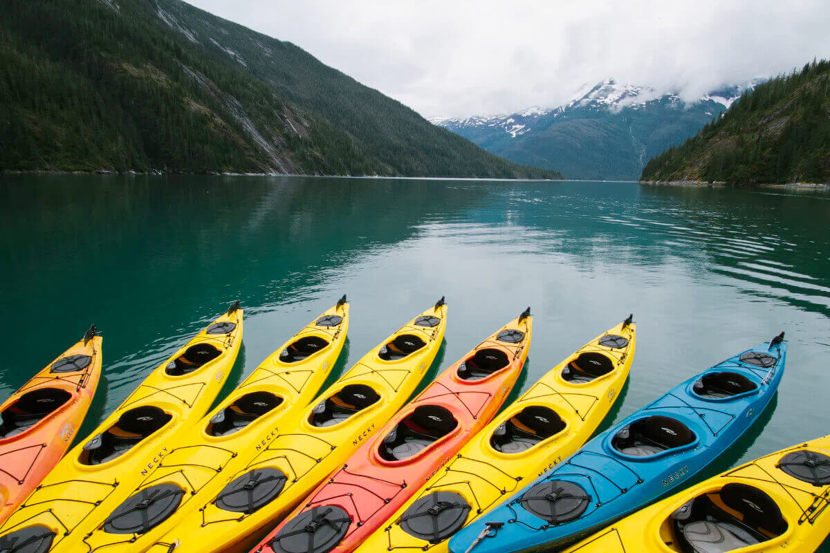 Colorful kayaks awaiting guests in an Alaska Fjord