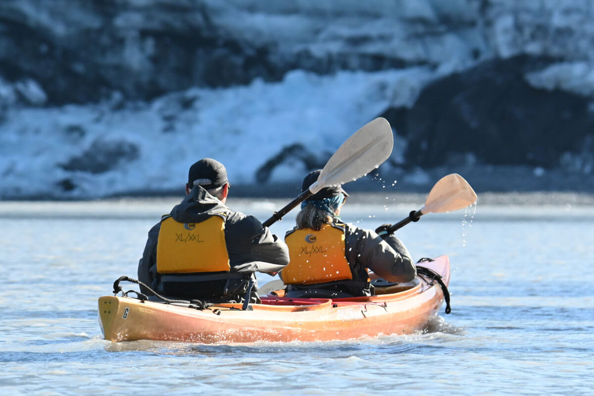 A couple of kayakers exploring glaciers