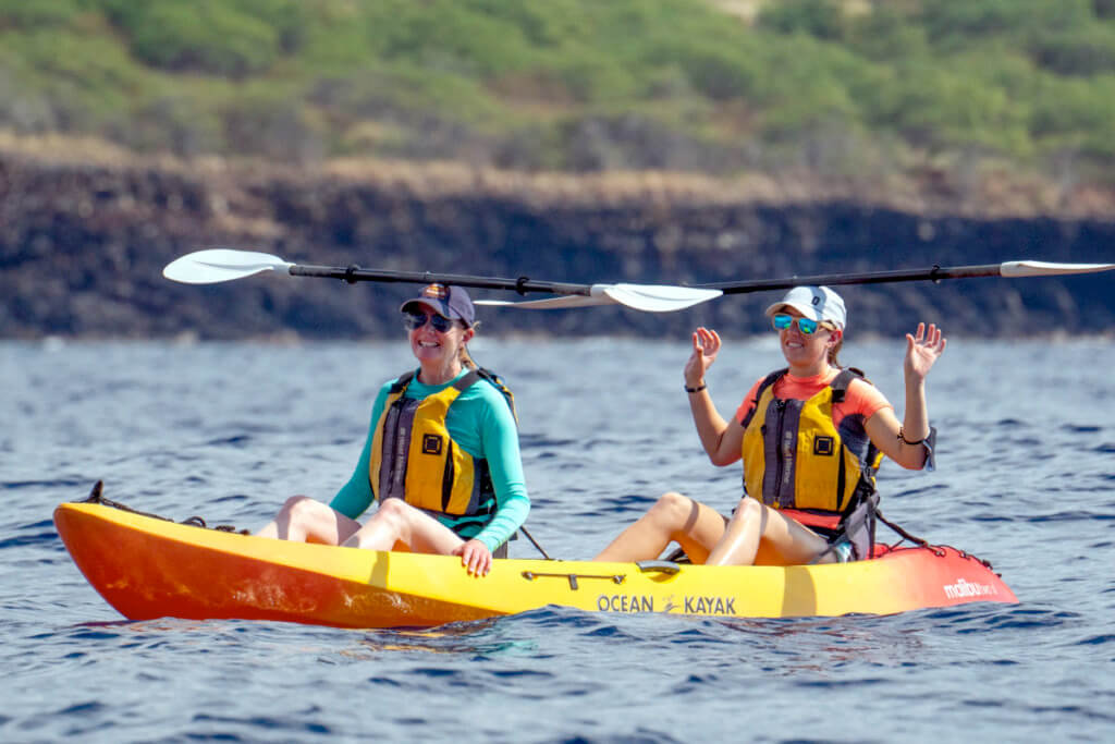 A couple of cruise guests in a sea kayak in Maui