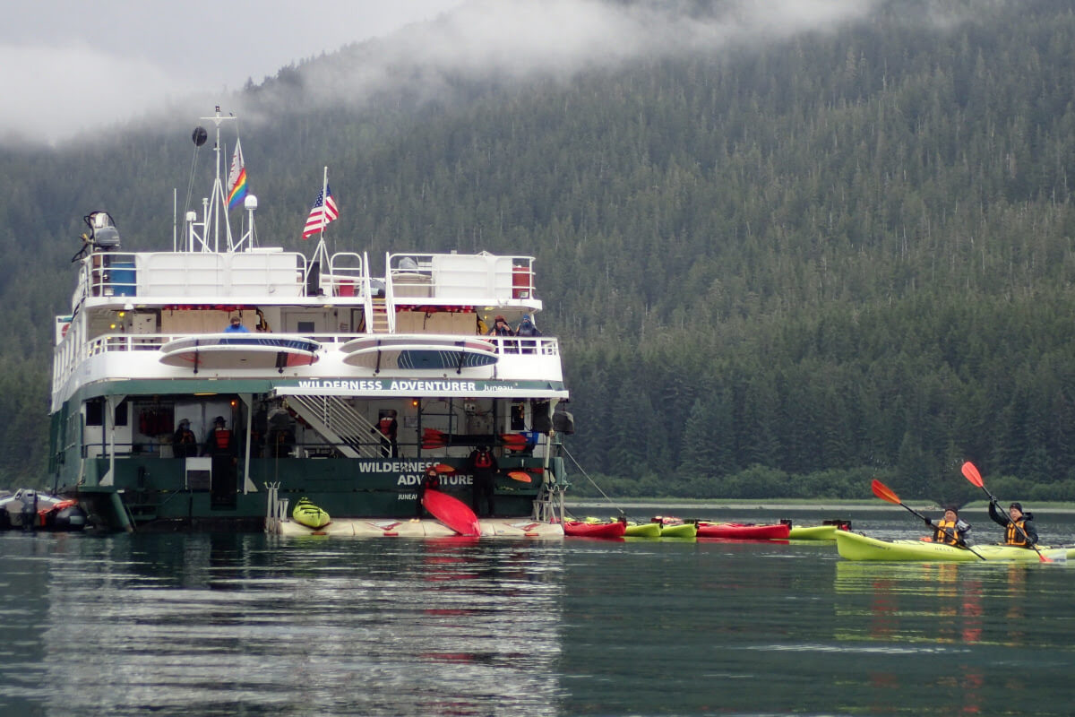 Wilderness Adventurer with kayakers nearby in Alaska