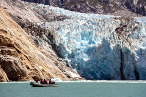 Skiff in front of Dawes Glacier, Alaska