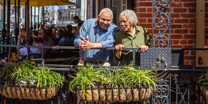 A couple standing on a balcony in New Orleans