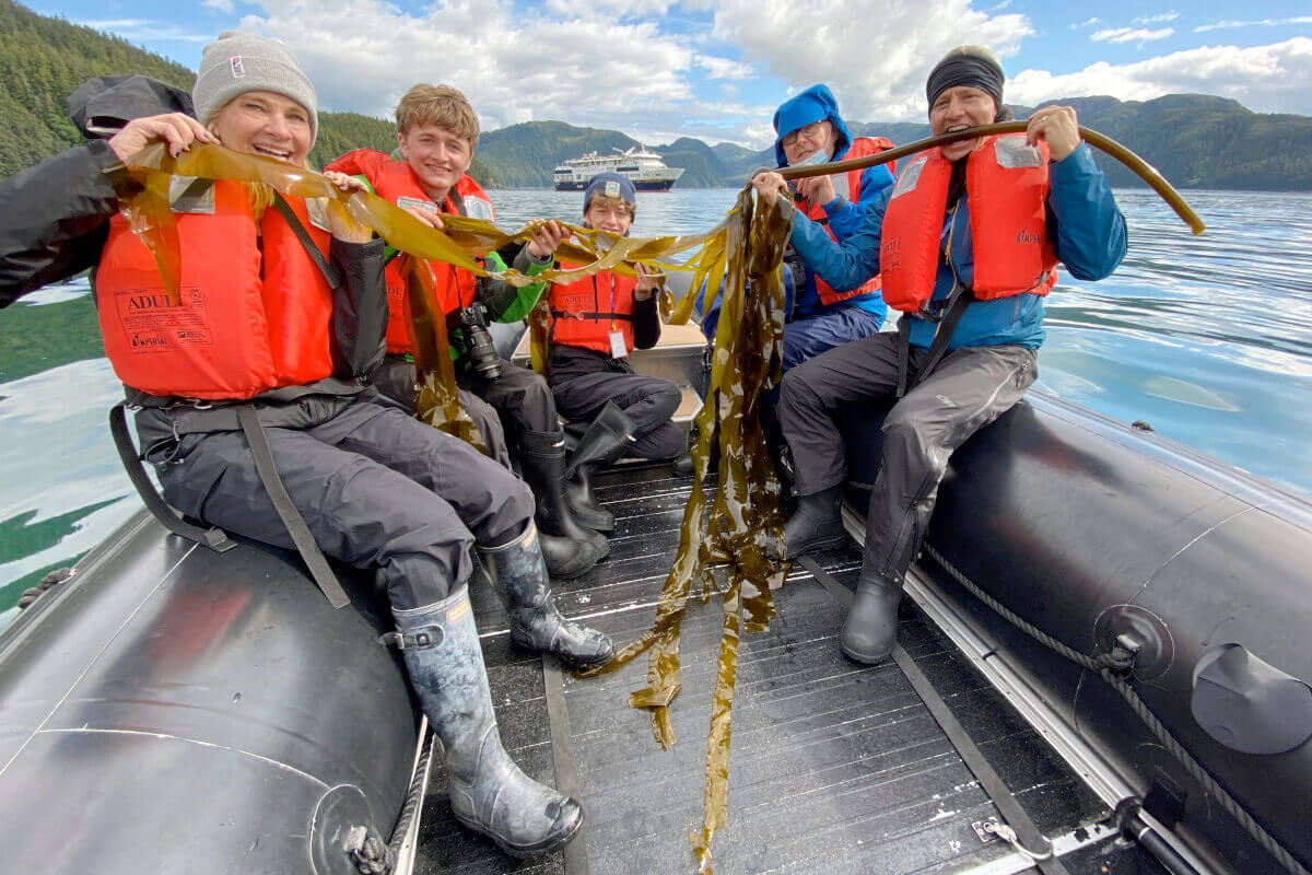 Happy cruise guests on a zodiac exploring the Inian Islands