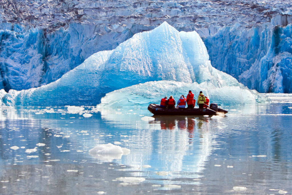 Zodiac filled with cruise guests exploring iceburgs in Glacier Bay