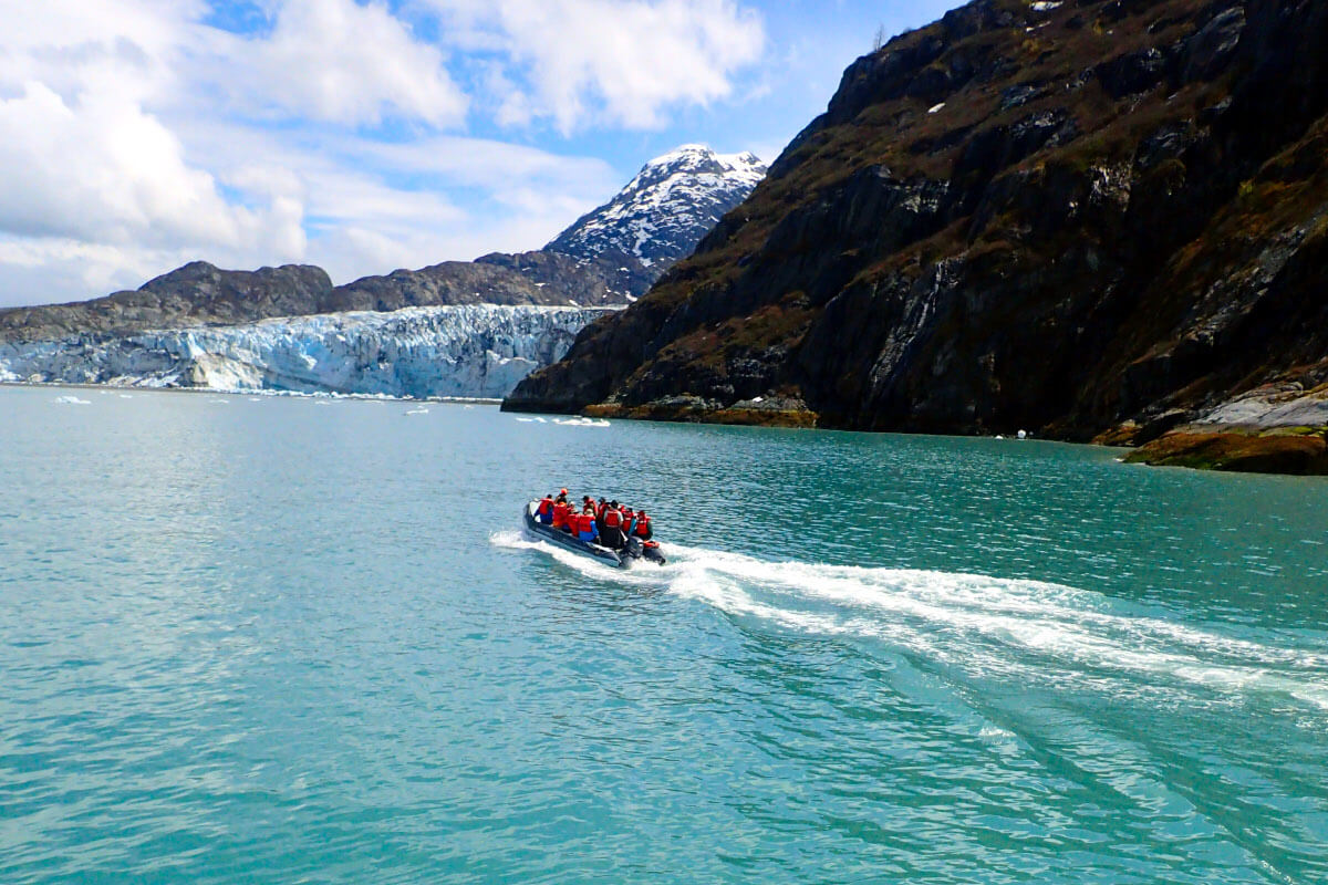 Skiff with passengers approaching a glacier