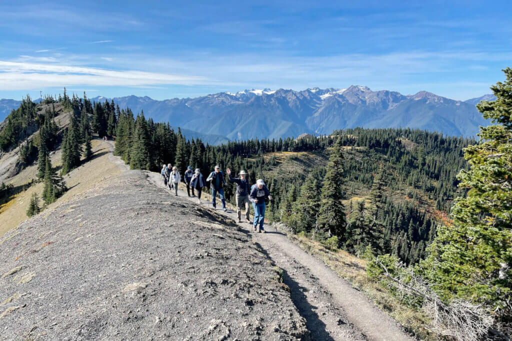 Guests hike along a mountainous ridge