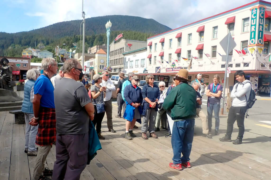 Cruise guests listen to a resident in Ketchikan, Alaska