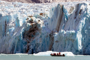 Skiff full of passengers getting up close to Dawes Glacier